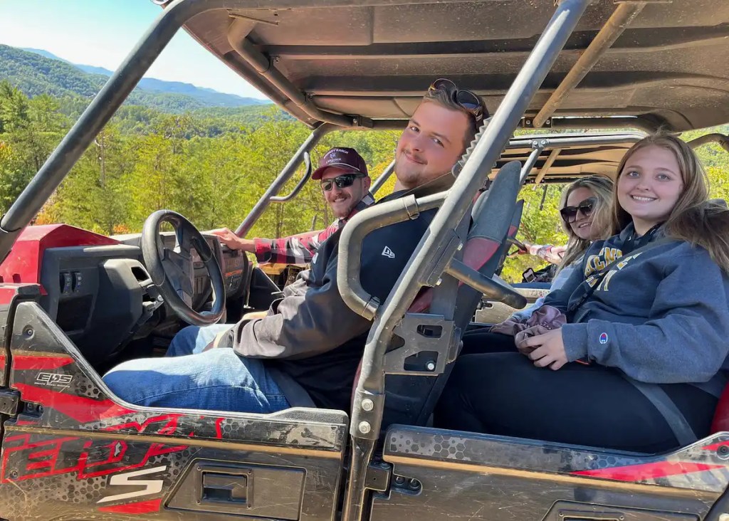 First-time riders seated in a UTV before an off-road adventure