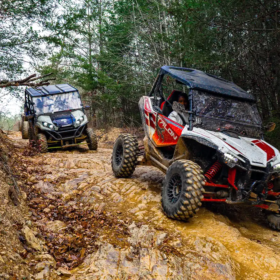 Two sport UTVs navigating a rocky off-road trail in Gatlinburg