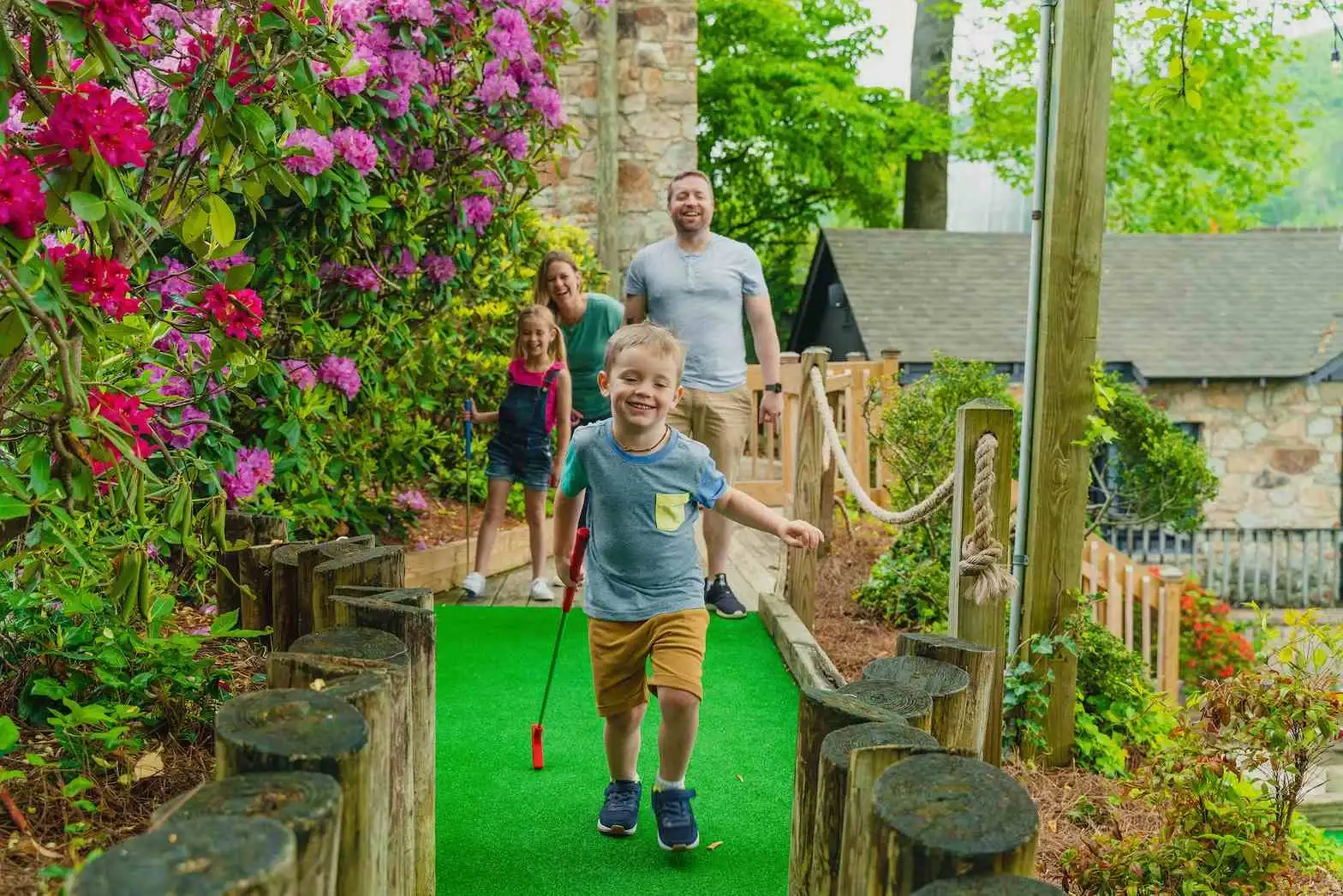A happy family playing golf in Gatlinburg