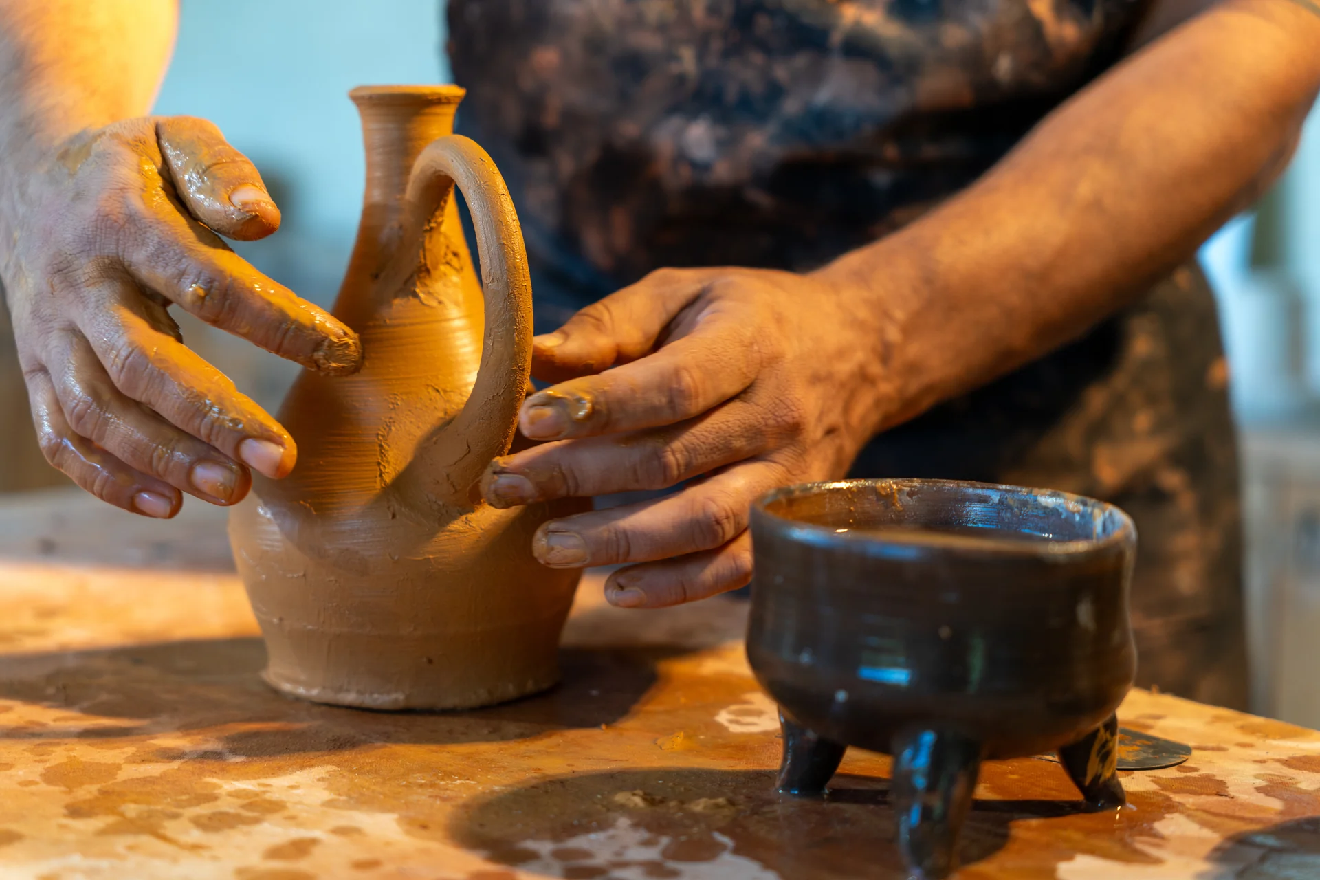 Artisan hand-crafting pottery, showcasing skills from the Great Smoky Arts and Crafts Community
