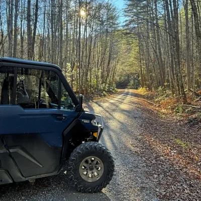 Enclosed Can-Am Defender in the forest | Side-bySide Rentals in Gatlinburg
